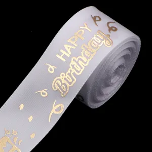 Close-up of white polyester ribbon with gold foil Happy Birthday print for gift box dec.