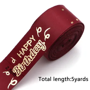Burgundy polyester ribbon with gold Happy Birthday print, 2.5cm wide, 5 yards long for gift wrapping.