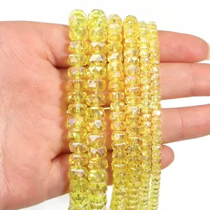Yellow faceted crystal rondelle spacer beads detail close-up for DIY jewelry crafting.