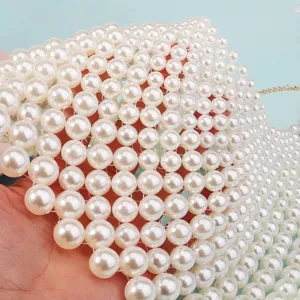 Pearl body chain detail close up, elegant tassel pearl chest chain accessory for women.