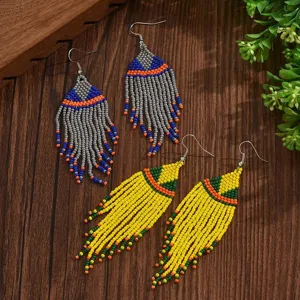 Close-up detail of bohemian beaded tassel earrings, ethnic style handmade geometric jewelry.