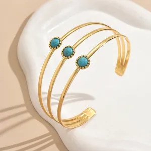 Bracciale rigido aperto multistrato dorato con pietre turchesi gioiello da donna.
