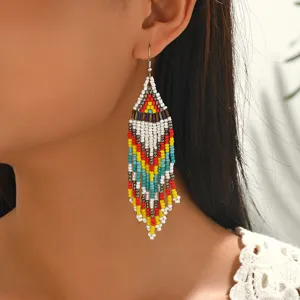 Detailed close-up shot of bohemian style geometric beaded fringe earrings with intricate design.