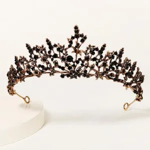 Detailed close-up of a vintage black crystal tiara crown, elegant gothic hair accessory.