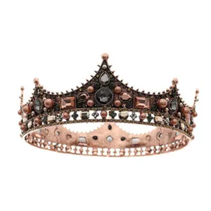 Vintage retro crown tiara detail, antique bronze metal with dark jewel embellishments.