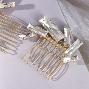 Detailed view of gold-tone hair comb with sparkling rectangular crystal rhinestones for elegant styling.