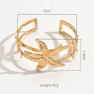 Gold open arm cuff bracelet featuring a geometric starfish flower design for women.