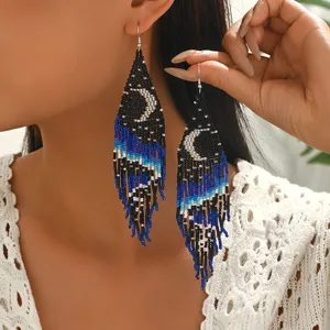 Exaggerated bohemian beaded tassel earrings featuring night sky moon design for women.
