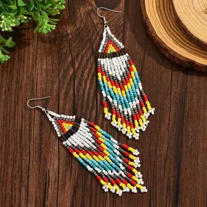 Handmade bohemian seed bead long tassel earrings detail view, colorful geometric pattern.
