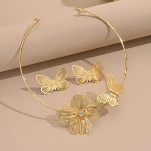 Detailed shot of gold-plated hollow butterfly and flower choker necklace with matching earrings.