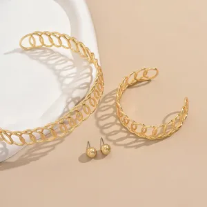 Stylish gold geometric winding metal open cuff bracelet and ball stud earrings jewelry set.