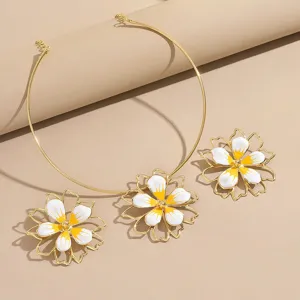 Gold plated enamel flower choker necklace and matching earrings jewelry set for women.