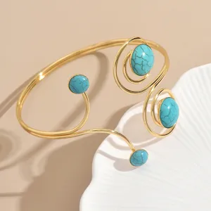 Bracciale rigido aperto geometrico color oro con pietre turchesi da donna gioielli moda.