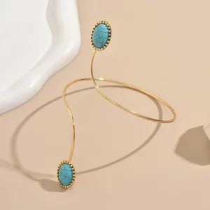 Bracciale da braccio a spirale dorato con pietre turchesi, gioiello geometrico di tendenza.