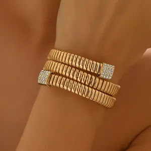 Exquisite multi-layer coil bracelet with sparkling rhinestone ends, elegant gold wrist jewelry detail.