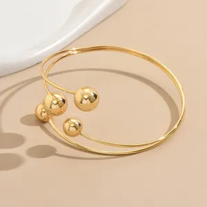 Bracciale polsino da braccio multistrato con sfere geometriche dorate da donna chic