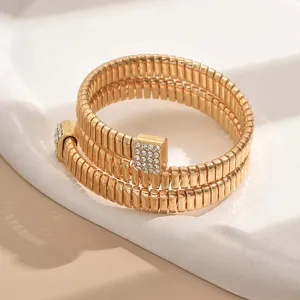 Detailed shot of a stylish multi-layer open metal coil stretch bracelet with rhinestone ends.