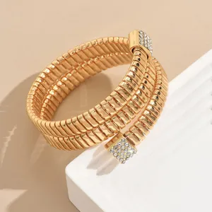 Exquisite multi-layer gold coil bracelet with sparkling rhinestones, elegant geometric spring design.