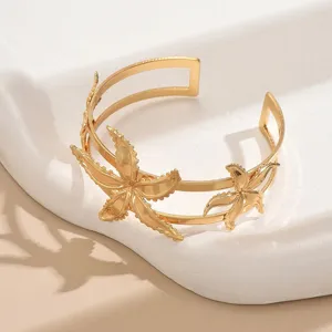 Exquisite gold open cuff armlet featuring delicate starfish details, perfect for summer style.