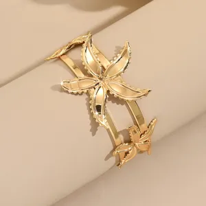 Close-up detail of the gold geometric flower open arm bracelet showcasing stylish metallic shine.