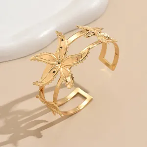 Gold geometric starfish flower open cuff arm bracelet for women fashion jewelry detail.