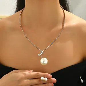 Closeup shot of trendy geometric metal choker necklace with elegant pearl pendant details.
