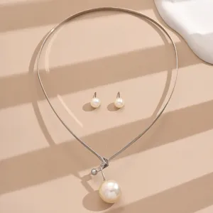 Pearl choker necklace and matching stud earrings jewelry set elegant detail view.