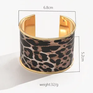 Wide leopard print cuff bracelet with gold metal trim, stylish geometric open design for women.