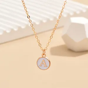 Minimalist gold-tone chain necklace featuring a chic round white enamel letter A pendant.
