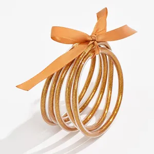 Transparante meerlagige glitter armbanden voor dames met oranje lintstrik hoofdaanzicht.