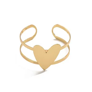 Minimalist gold double band open cuff bracelet with a stylish statement heart for women.