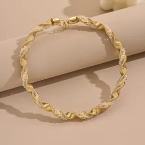 Geometric wrapped crystal choker detail shot, gold spiral design for party and daily fashion.