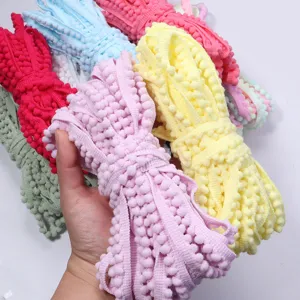 Close-up detail of colorful pom-pom trim ribbon, perfect for DIY crafts and sewing projects.