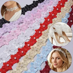 Detailed view of colorful lace ribbon trim with embroidered flowers and faux pearl beads.