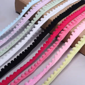 Colorful pom-pom fringe trim detail showing various vibrant ribbon colors for DIY craft projects.
