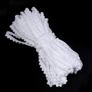 Detailed view of white pom pom trim, ideal for sewing, garment accessories and DIY crafts.