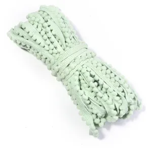 Light green pom pom trim fringe ribbon for DIY crafts, sewing accessories and garment decor.