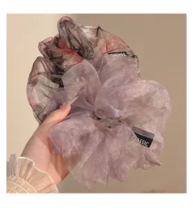 Close-up detail of lightweight organza hair scrunchie, soft sheer texture for stylish everyday ponytails.