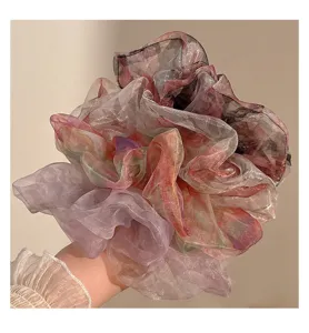 Detail view of large organza hair scrunchie, fluffy gradient mesh ponytail holder for women styling.