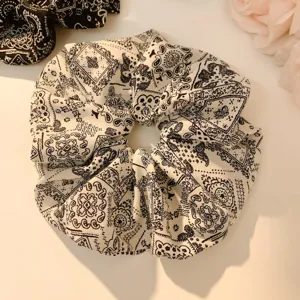 Close-up detail of vintage paisley print fabric hair scrunchy, elegant daily hair accessory.