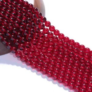Rote Edelsteinperlen Detailansicht, glatte Perlenoberflaeche, ideal fuer DIY Schmuckdesign.