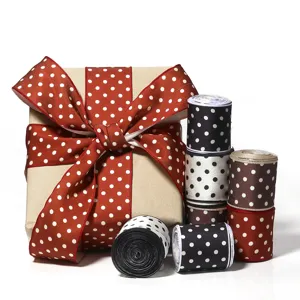Polka dot ribbon rolls and gift box detail view, perfect for DIY crafts and wrapping.