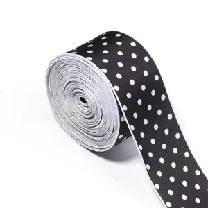 Black and white polka dot ribbon roll for DIY crafts, hair accessories, and clothing trim.