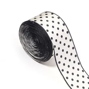 Black and white polka dot ribbon roll for DIY hair bows, gift wrapping and sewing accessories.