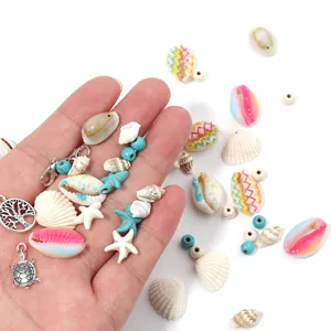 Close-up detail of natural seashells, turquoise beads, and silver charms for DIY jewelry making.