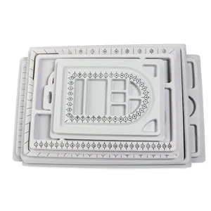 Grey plastic bead design board with measurement scales for DIY jewelry making and bracelet sizing.