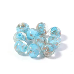 Blue glass bead detail shot, gold foil glitter texture, DIY jewelry making accessory part.