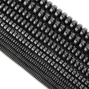 Detail shot of black hematite wheel beads, sorted by size for jewelry making.