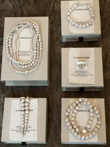 Detailed display of handmade natural white fossil beaded jewelry set with neo-Chinese style.