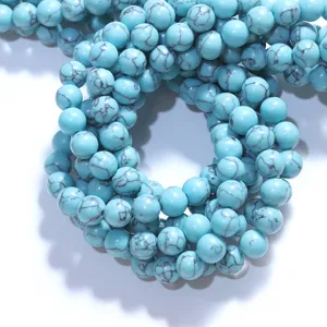 Close-up detail of synthetic turquoise loose round beads, perfect for DIY jewelry making.